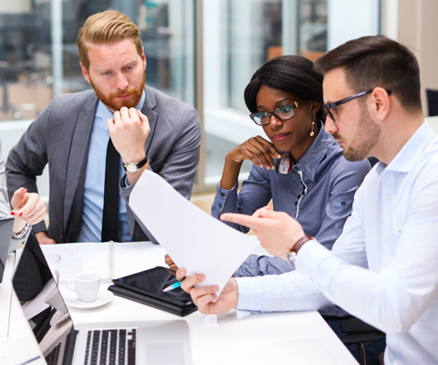 men and woman at computer working